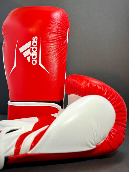 Adidas WAKO Approved Kickboxing Fight Gloves, Cowhide Cuir Leather Speed 165 adiSBG165 Competition Gloves 10 Oz Red on floor